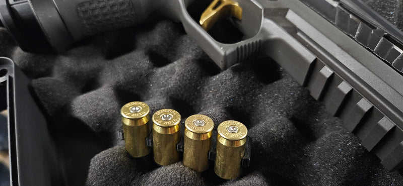 Set of 4 Brass Bullet Valve Stem Caps, Tire Caps, Dust Covers, sitting in gun case next to gun